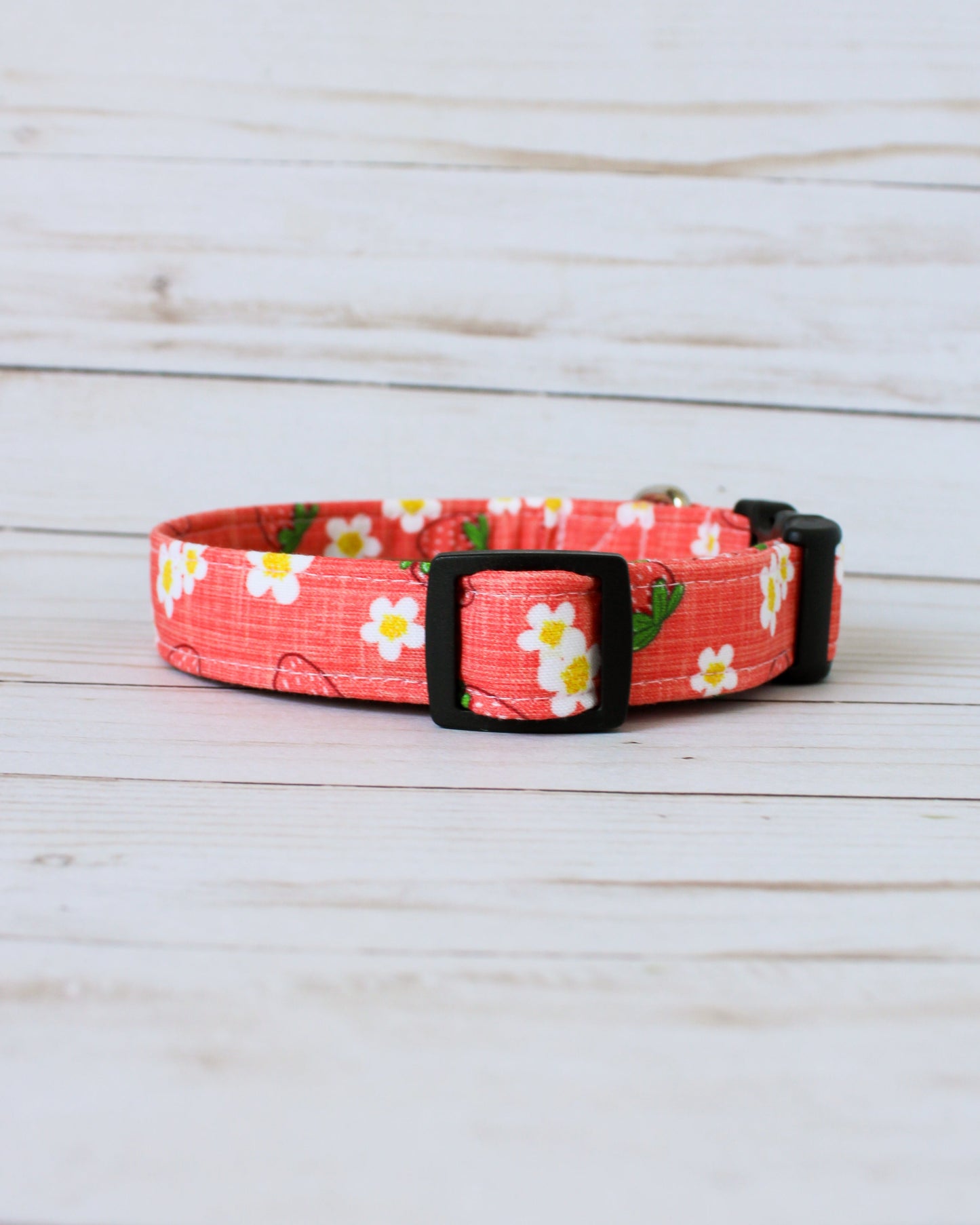 Floral patterned dog collar on a wooden surface