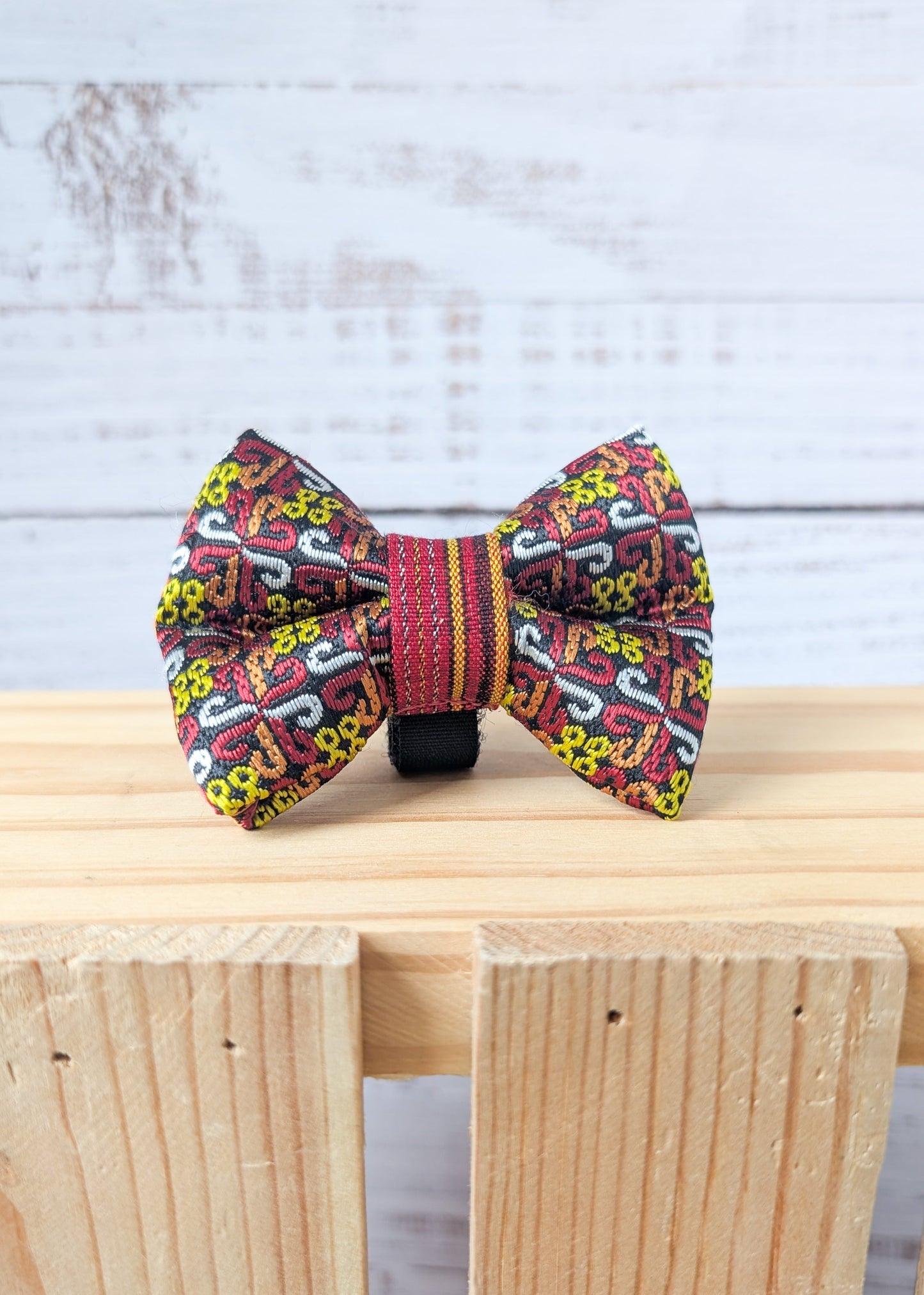 Colorful bow tie with intricate patterns on a wooden surface