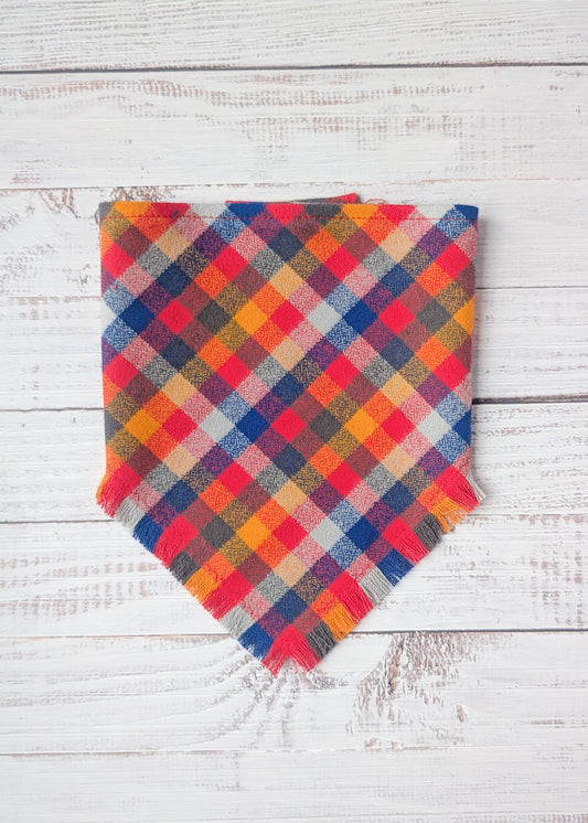 Colorful Flannel bandana with yellow, red, blue, pale blue colors on a wooden background