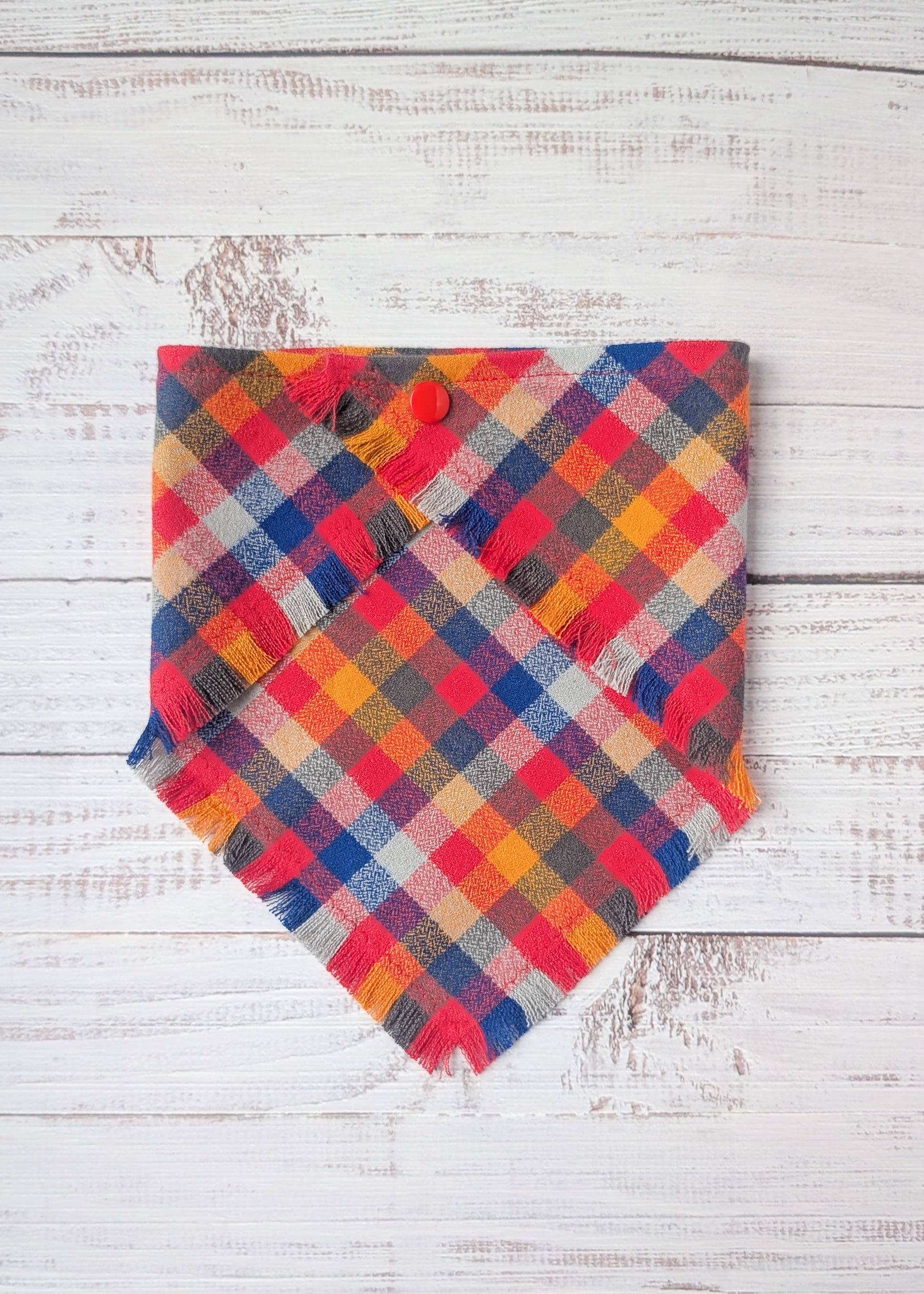 Colorful Flannel bandana with yellow, red, blue, pale blue colors on a wooden background