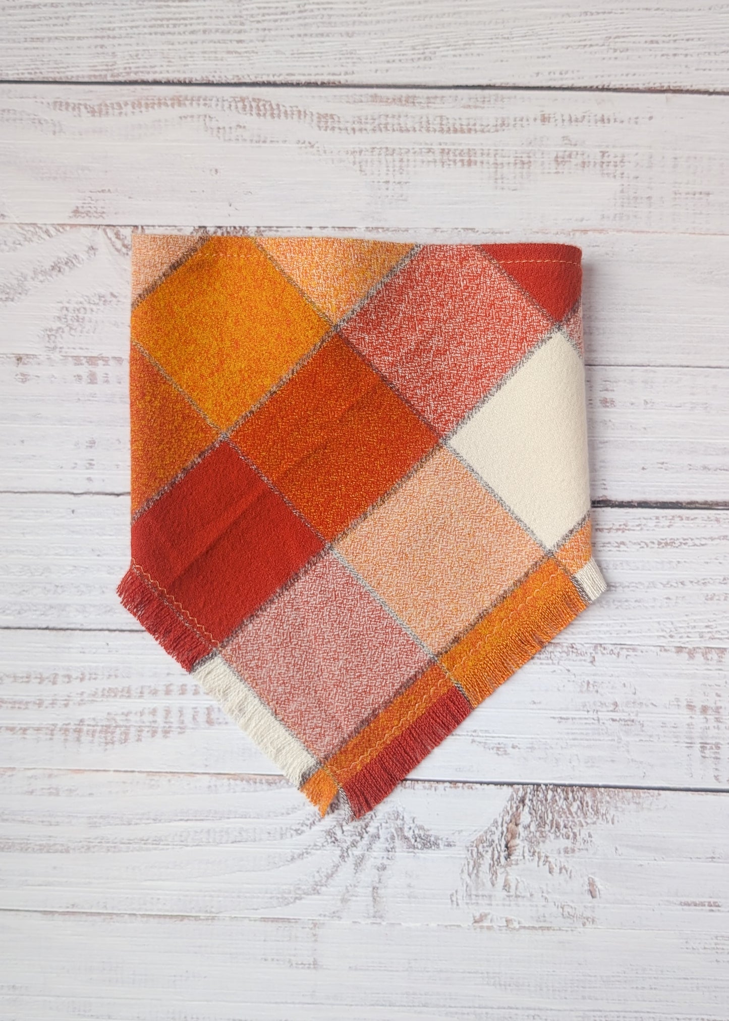 Orange white and yellow bandana on a wooden background 