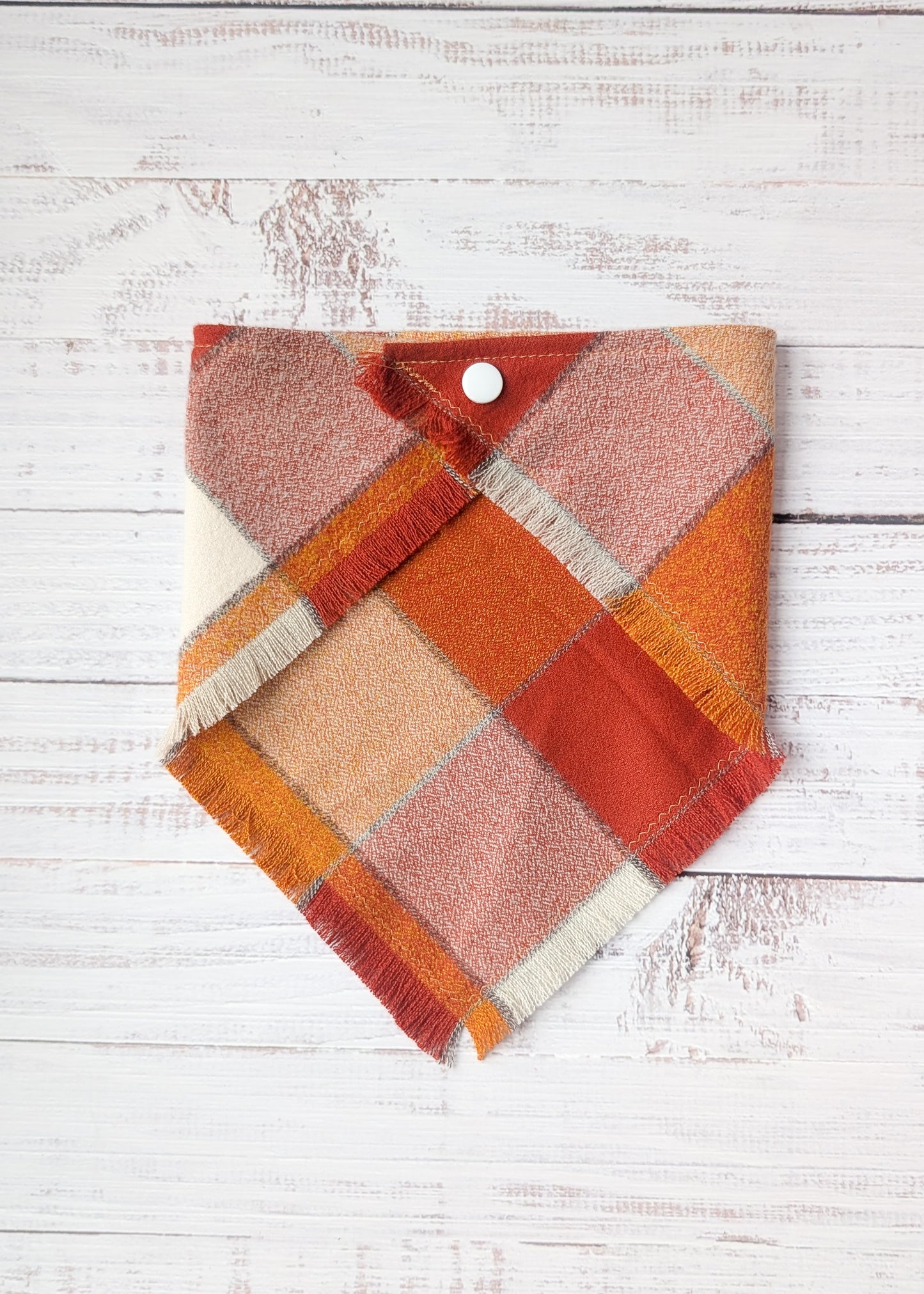 Orange white and yellow bandana on a wooden background 