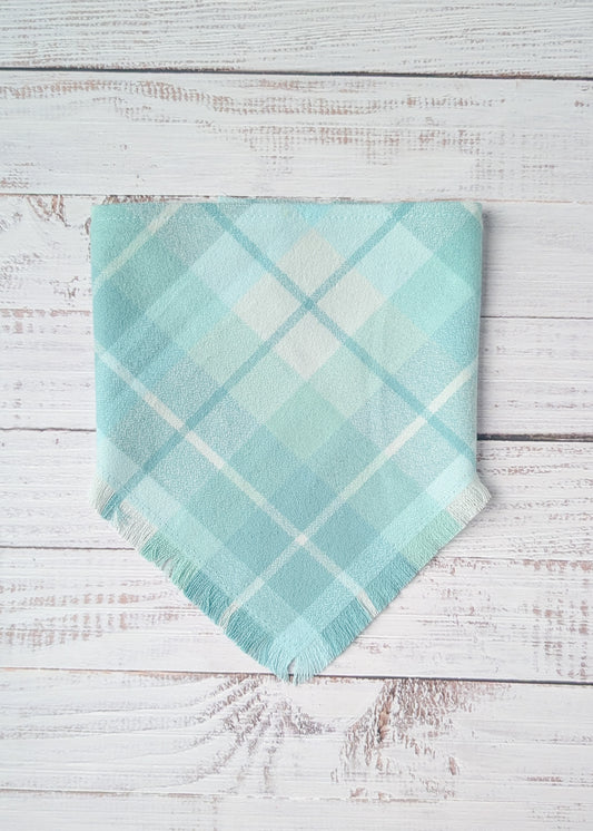 Turquoise plaid flannel bandana on a wooden surface