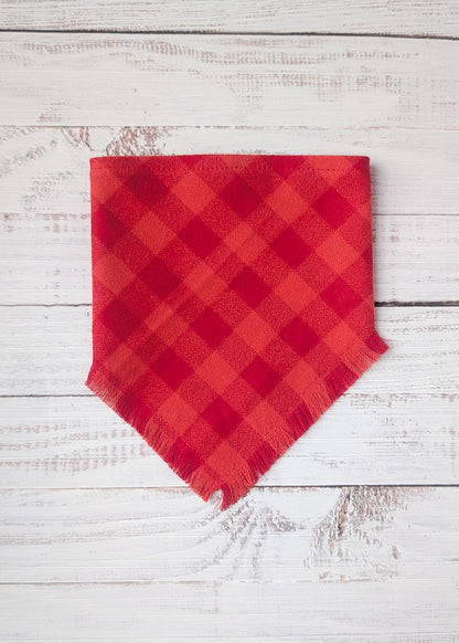 Red plaid flannel bandana  on a white wooden background