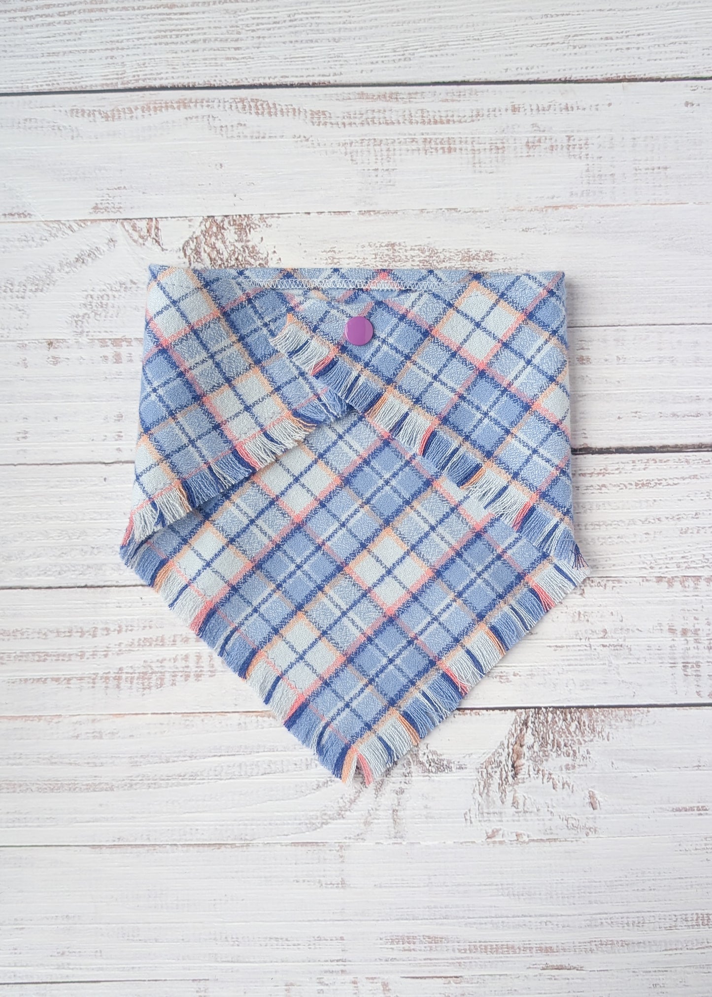 Blue plaid flannel bandana on a wooden surface