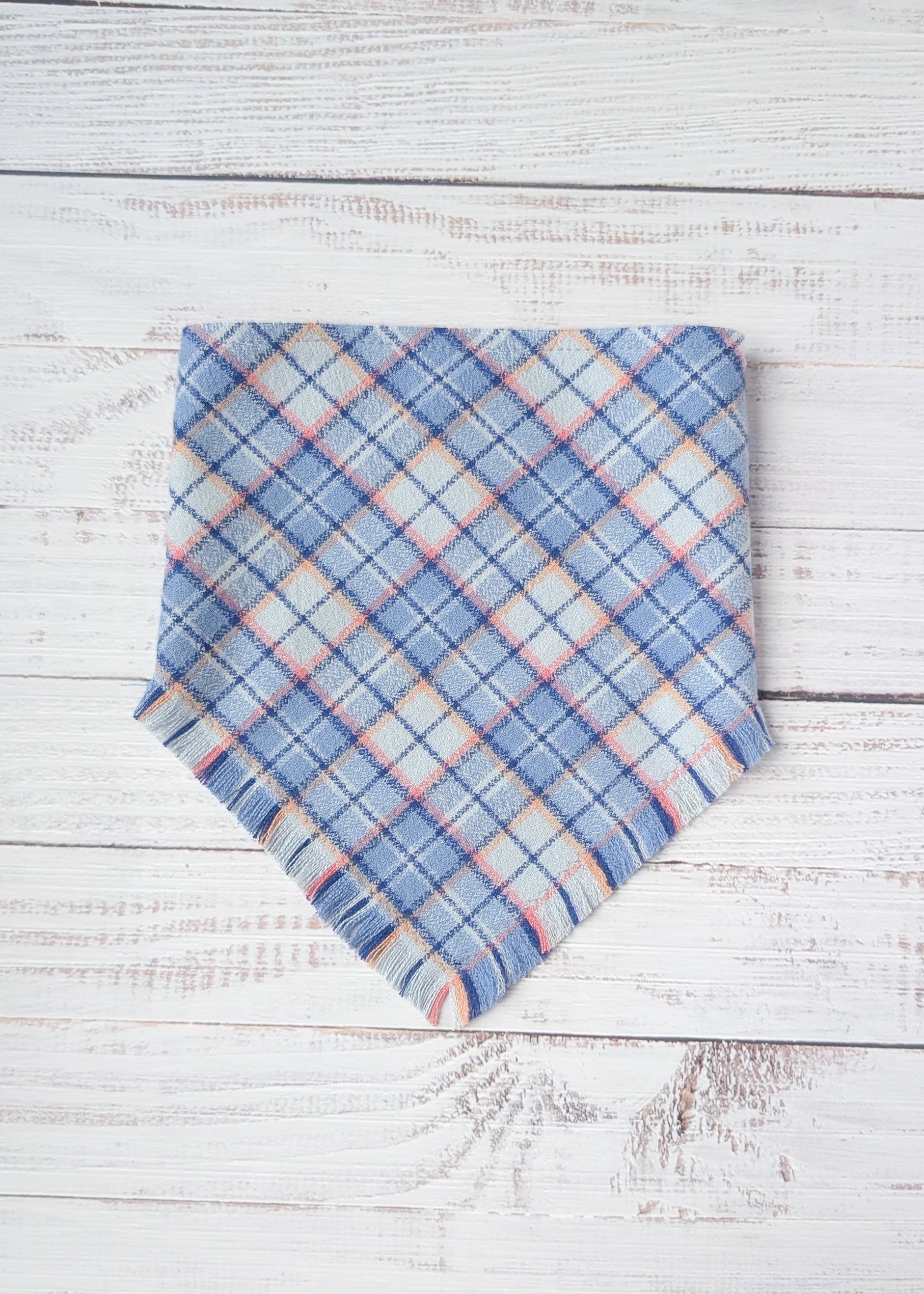 Blue plaid flannel bandana on a wooden surface