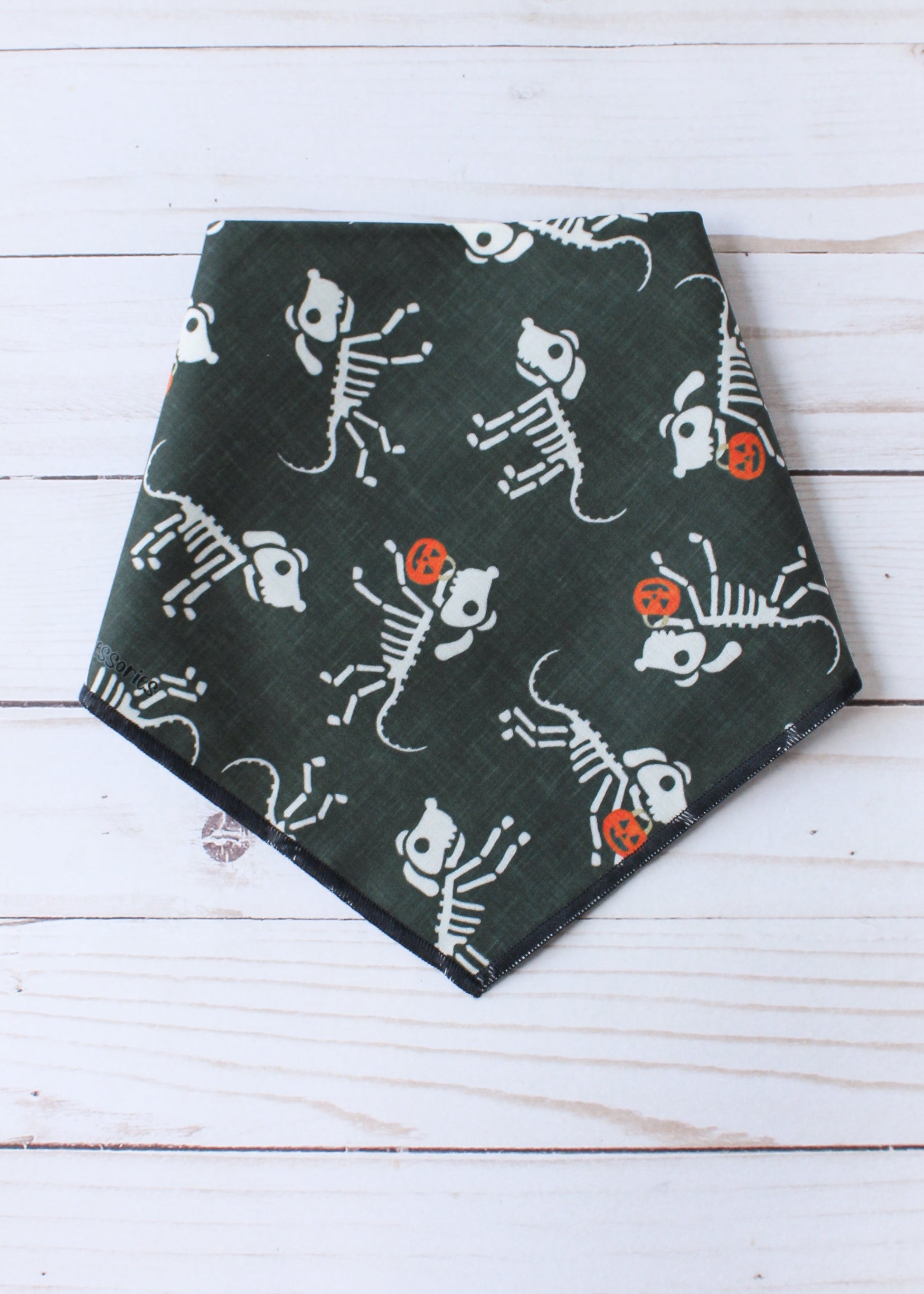 Dog bandana with skeleton dog design on a white wooden background