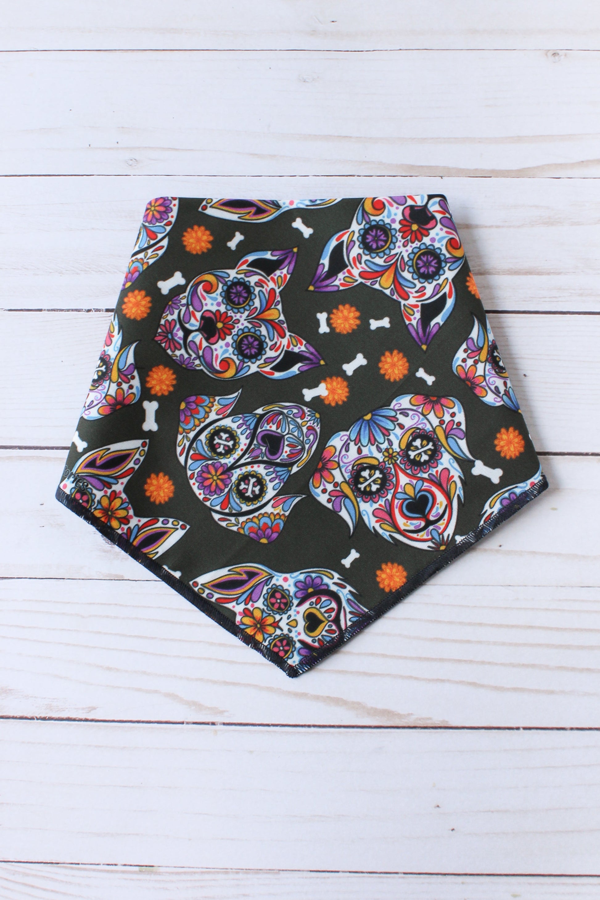 Colorful skull patterned bandana on a wooden surface