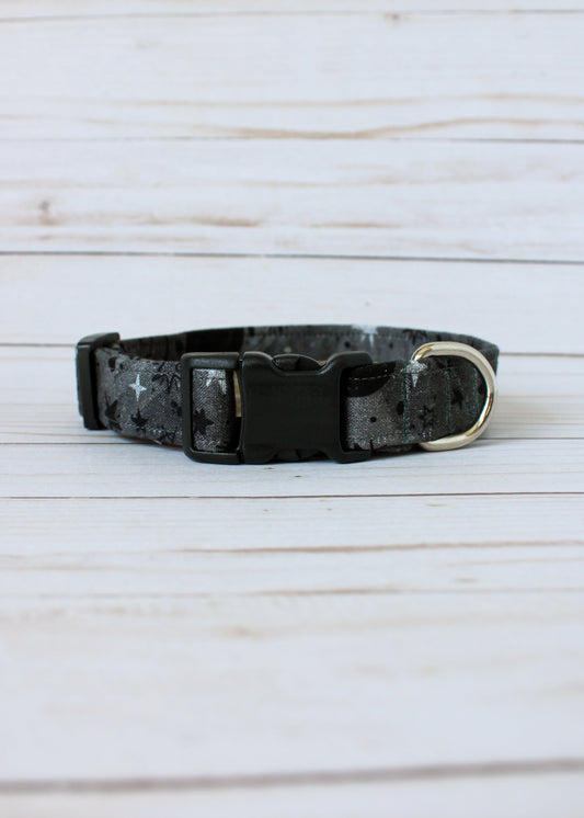 Black and gray patterned dog collar on a light wooden surface