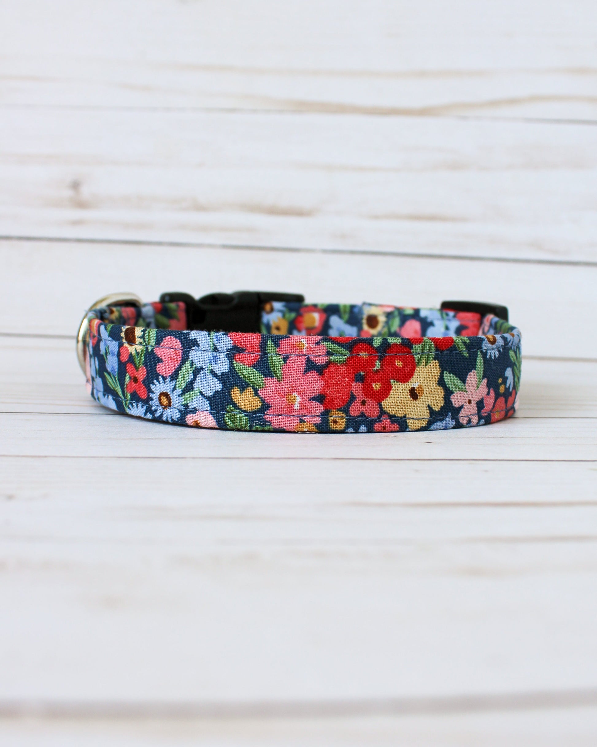 Floral patterned dog collar on a light wooden background