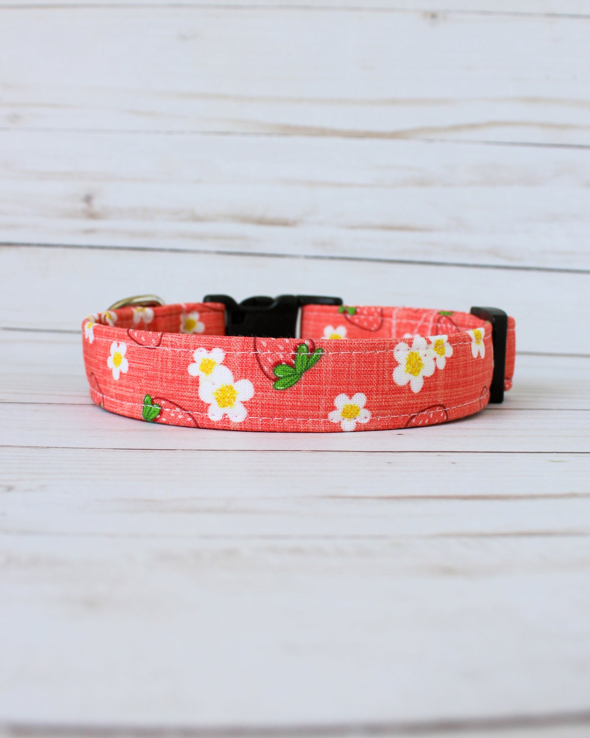 Floral-patterned dog collar on a wooden surface