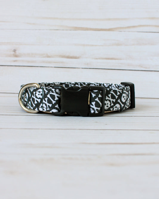 Black dog collar with white pattern on a light wooden surface