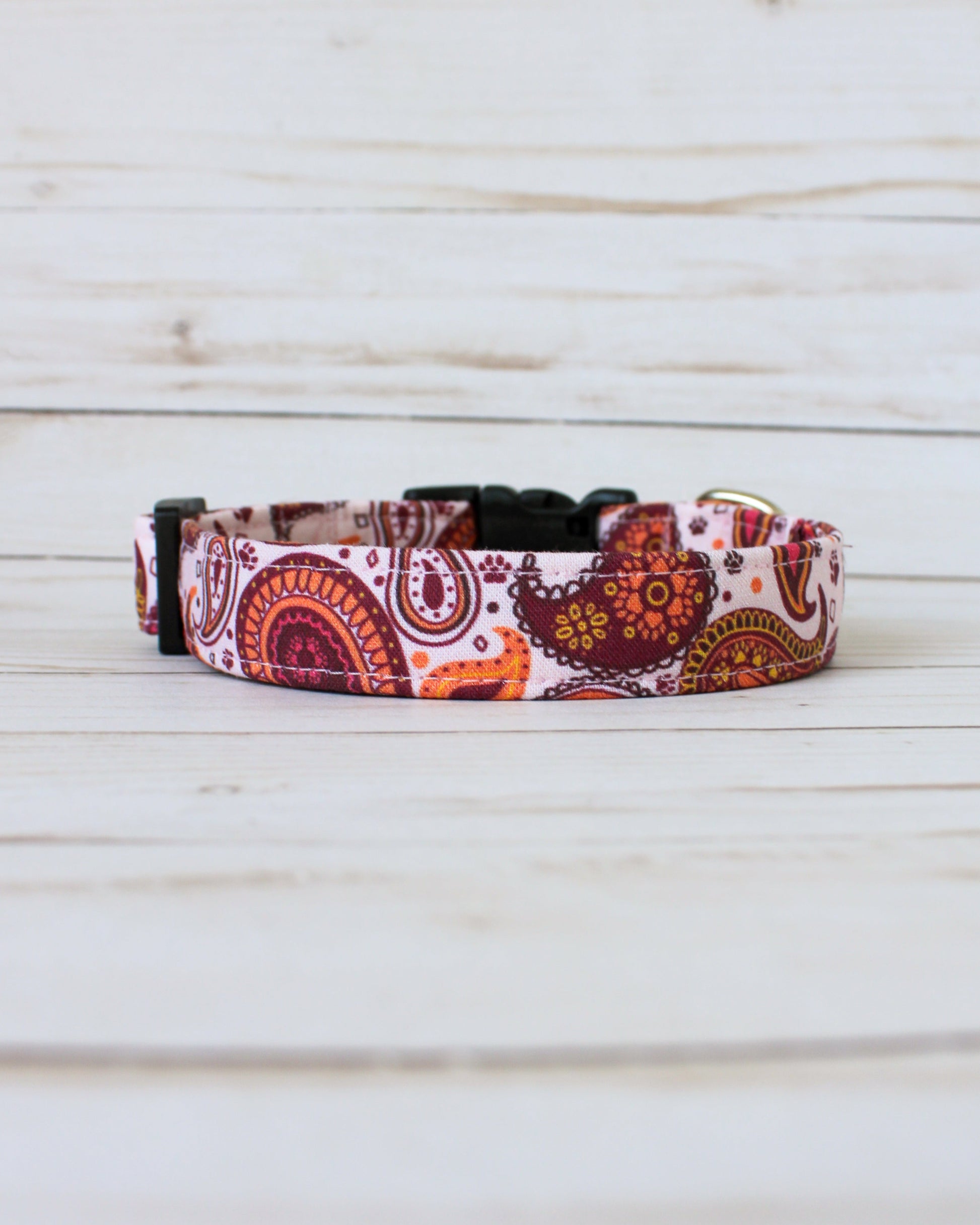 paisley Patterned dog collar on a wooden surface