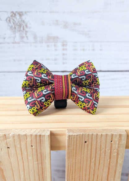 Colorful bow tie with intricate patterns on a wooden surface