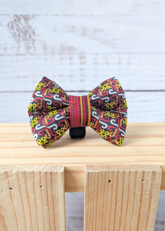 Colorful bow tie with intricate patterns on a wooden surface