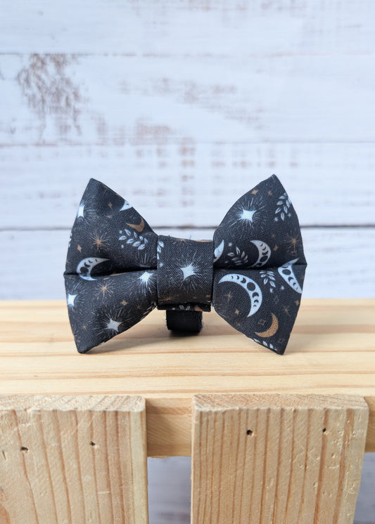 Dog bow tie with a celestial pattern on a black background