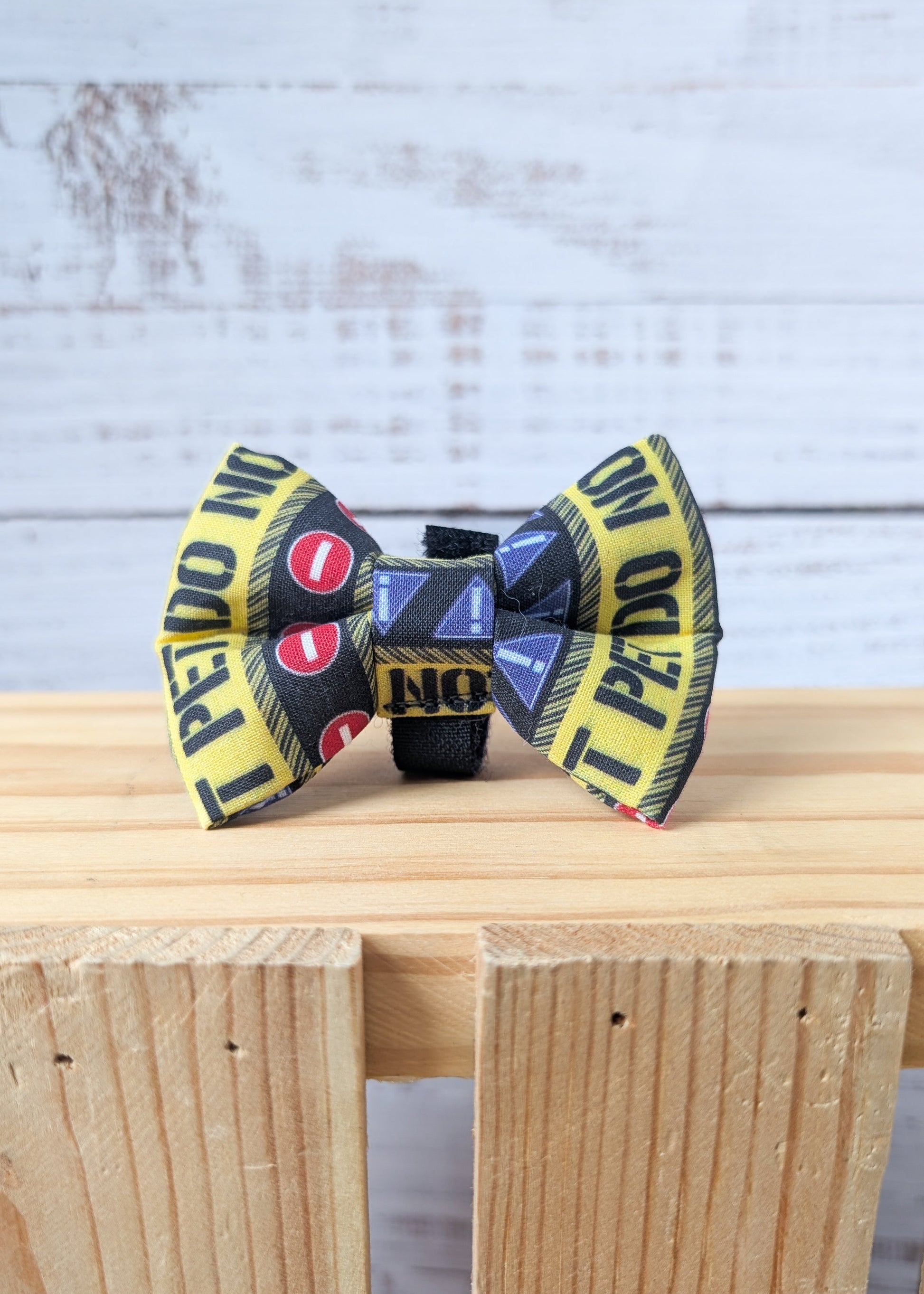 Dog bow tie with a pattern that says "Do Not Pet" 
