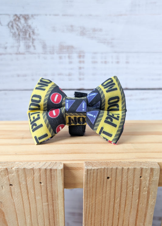 Dog bow tie with a pattern that says "Do Not Pet" 