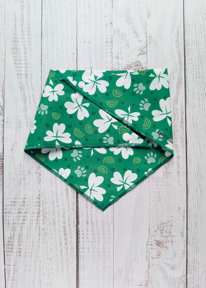 Green bandana with white shamrock patterns on a wooden surface