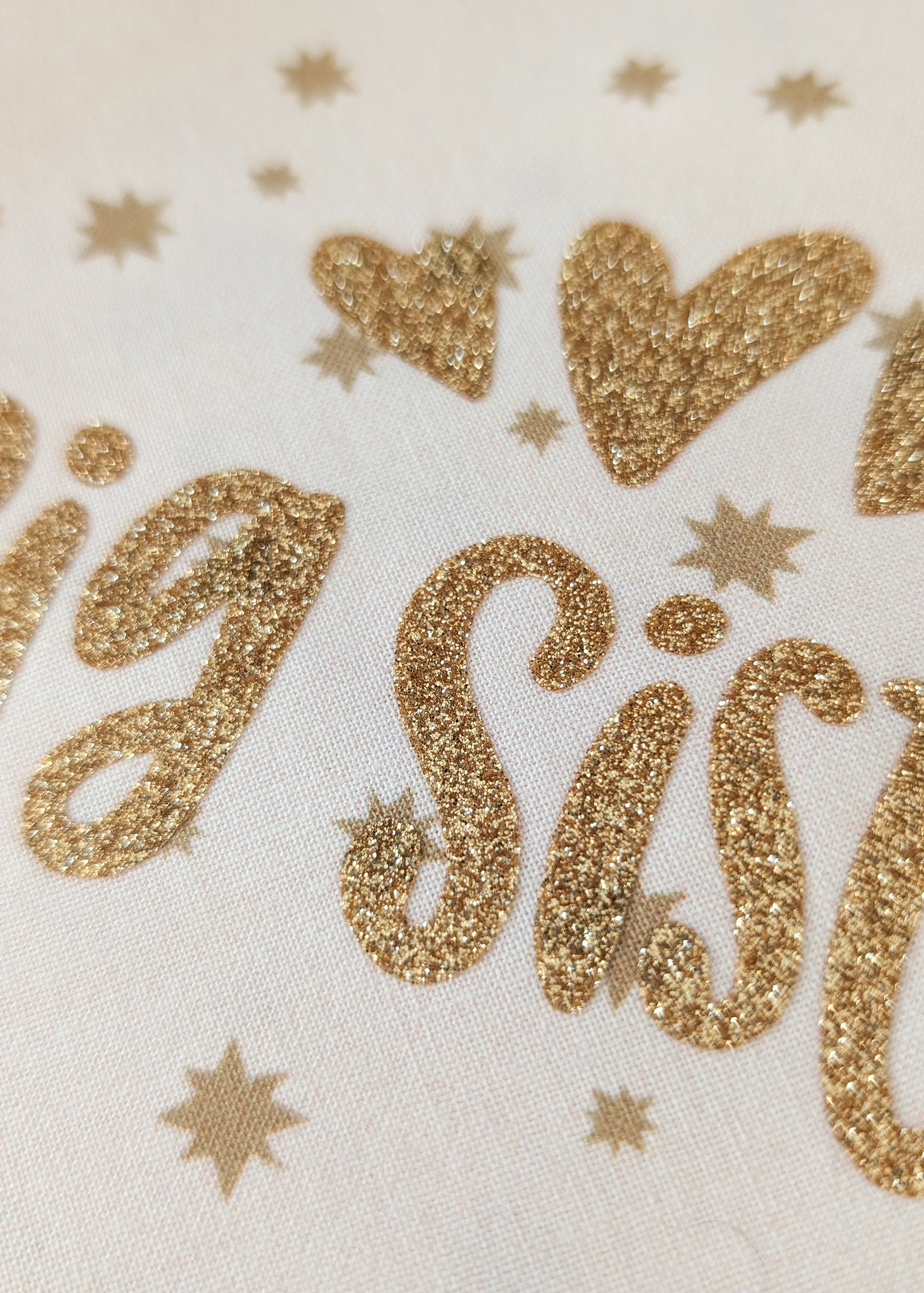 Gold glittery 'Big Sister' text on a white background with stars.