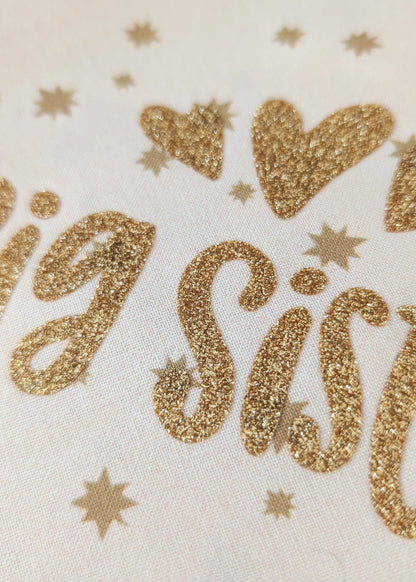 Gold glittery 'Big Sister' text on a white background with stars.