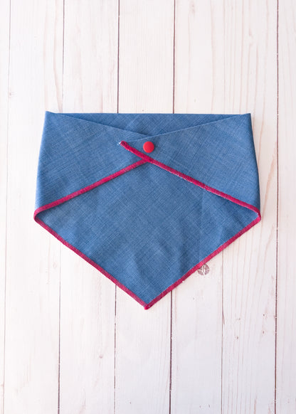 blue denim bandana with red trim and snap on wooden background