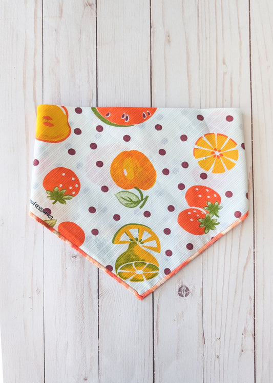 White bandana with fruit theme and polka dots on white wooden background