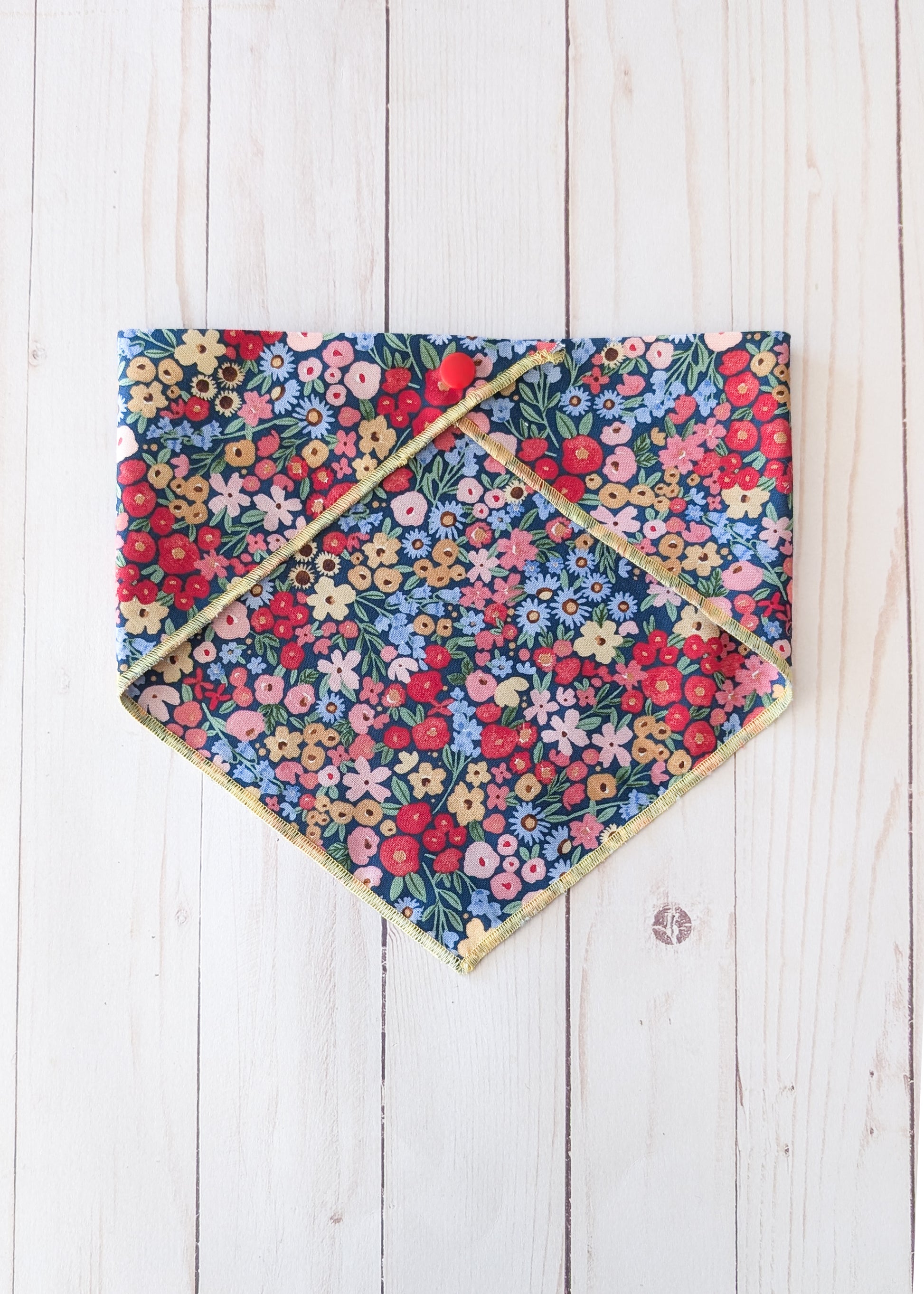 Dark blue bandana with flower pattern on white wooden background