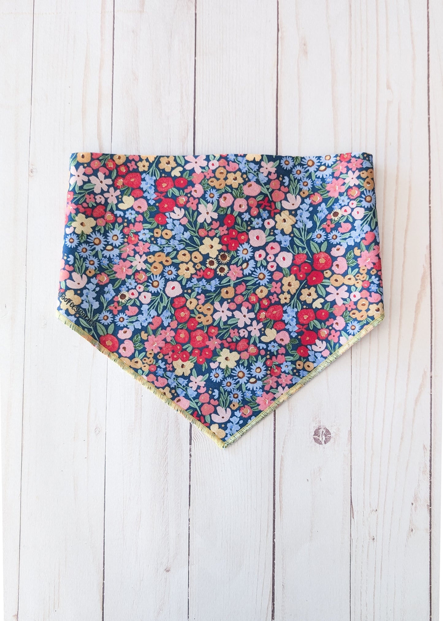 Dark blue bandana with flower pattern on white wooden background