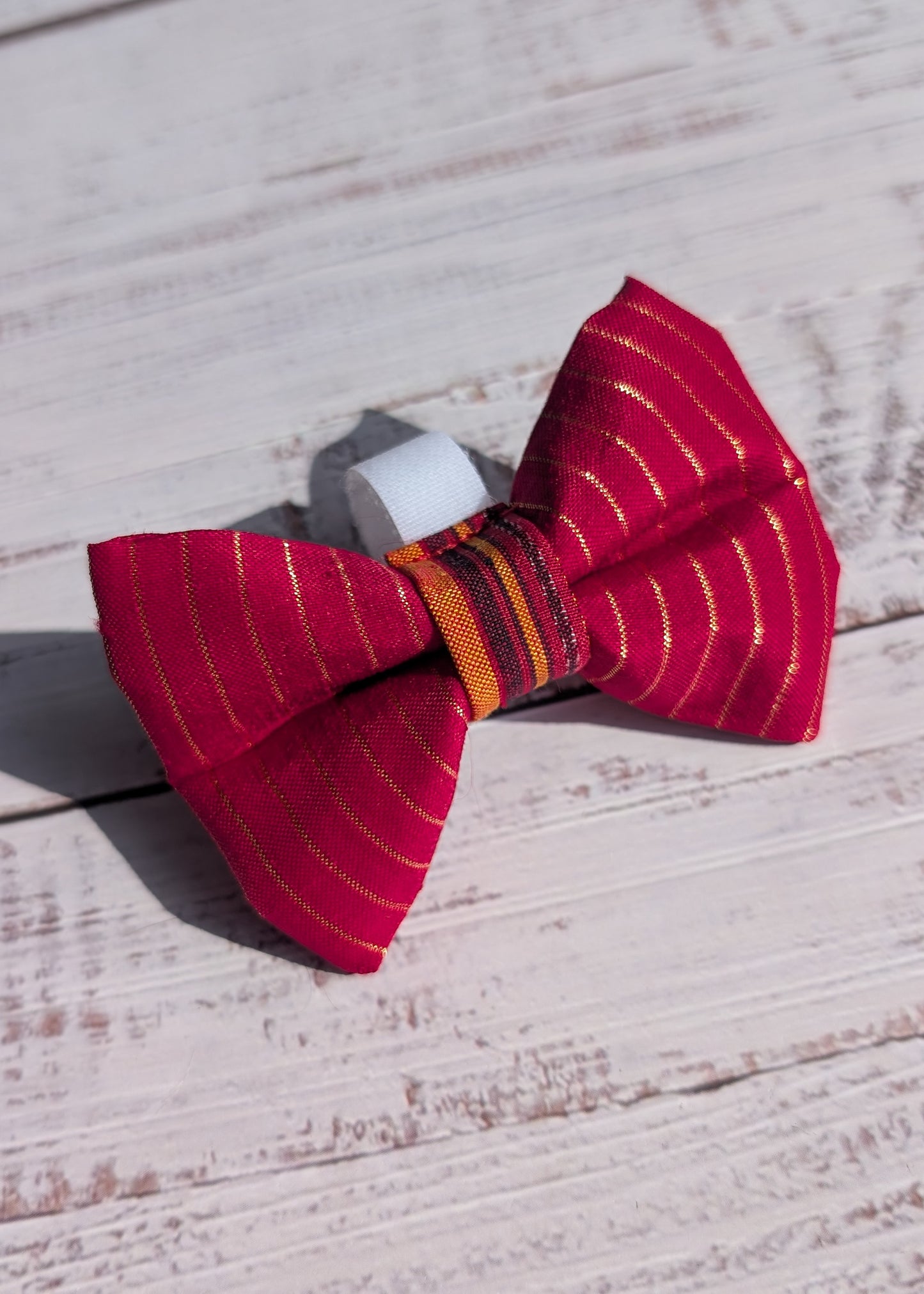 Red striped bow tie on a wooden surface