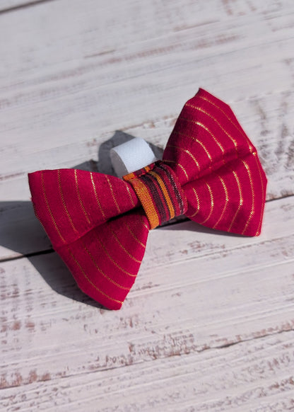 Red striped bow tie on a wooden surface