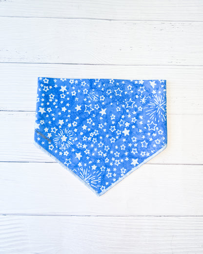 Blue bandana with white star pattern on a light wooden surface