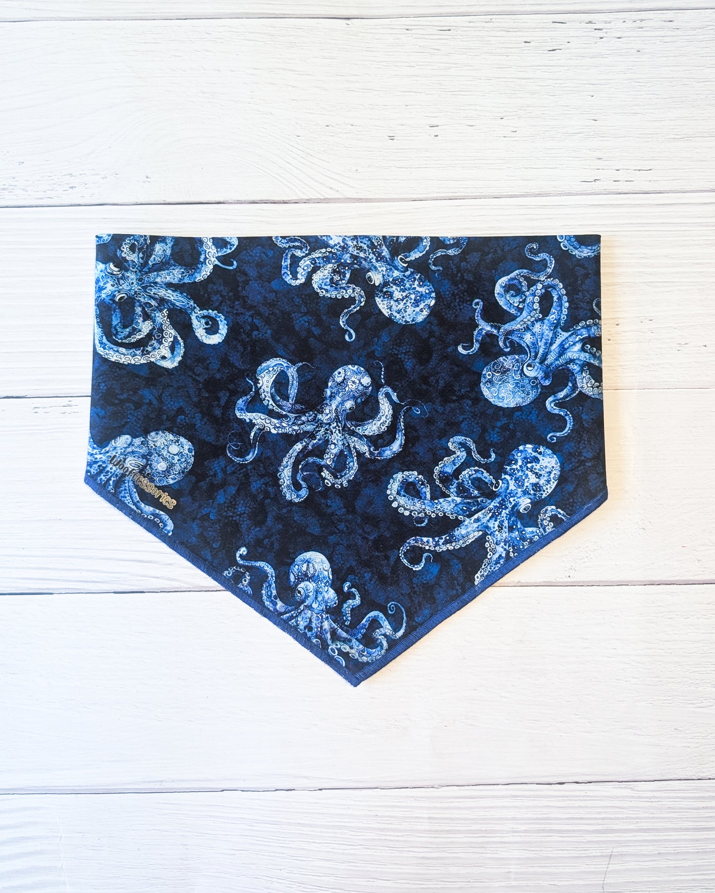 Blue bandana with octopus pattern on a white wooden background