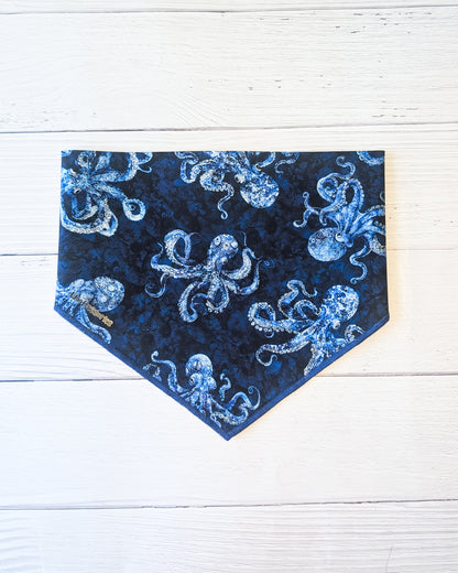 Blue bandana with octopus pattern on a white wooden background