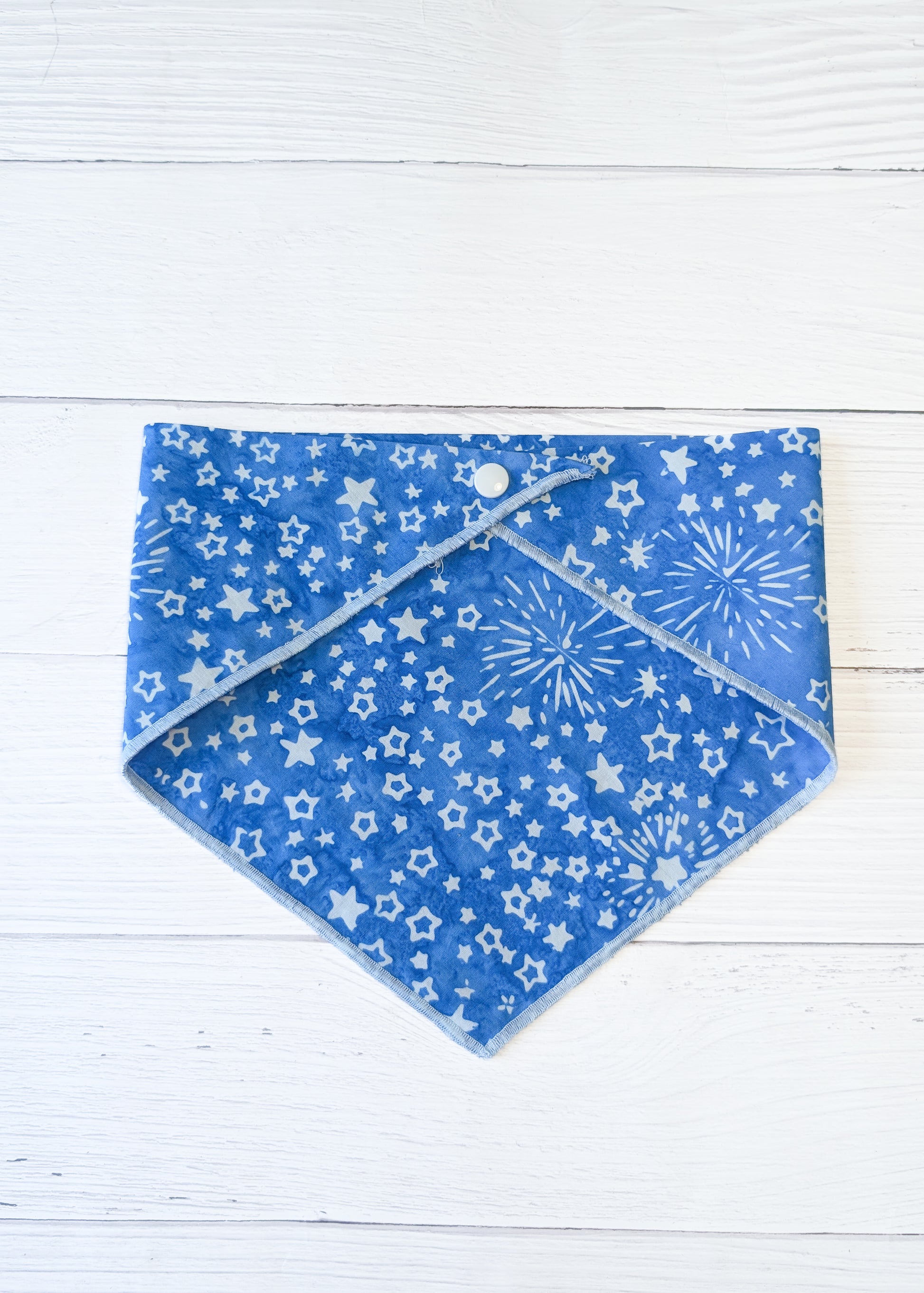 Blue bandana with star pattern on a white wooden surface