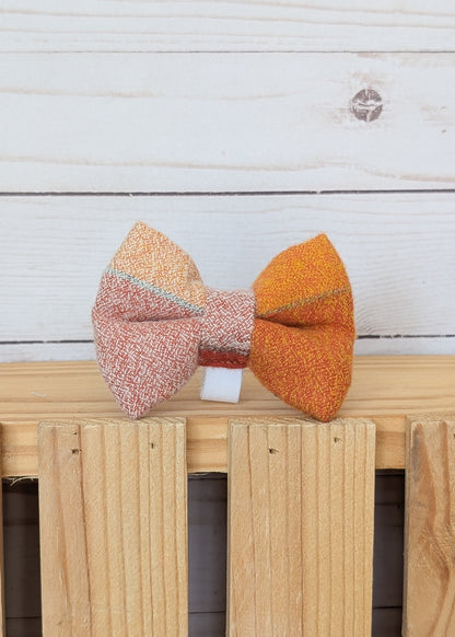 A handmade fabric bow tie with a yellowish brown tan flannel plaid design