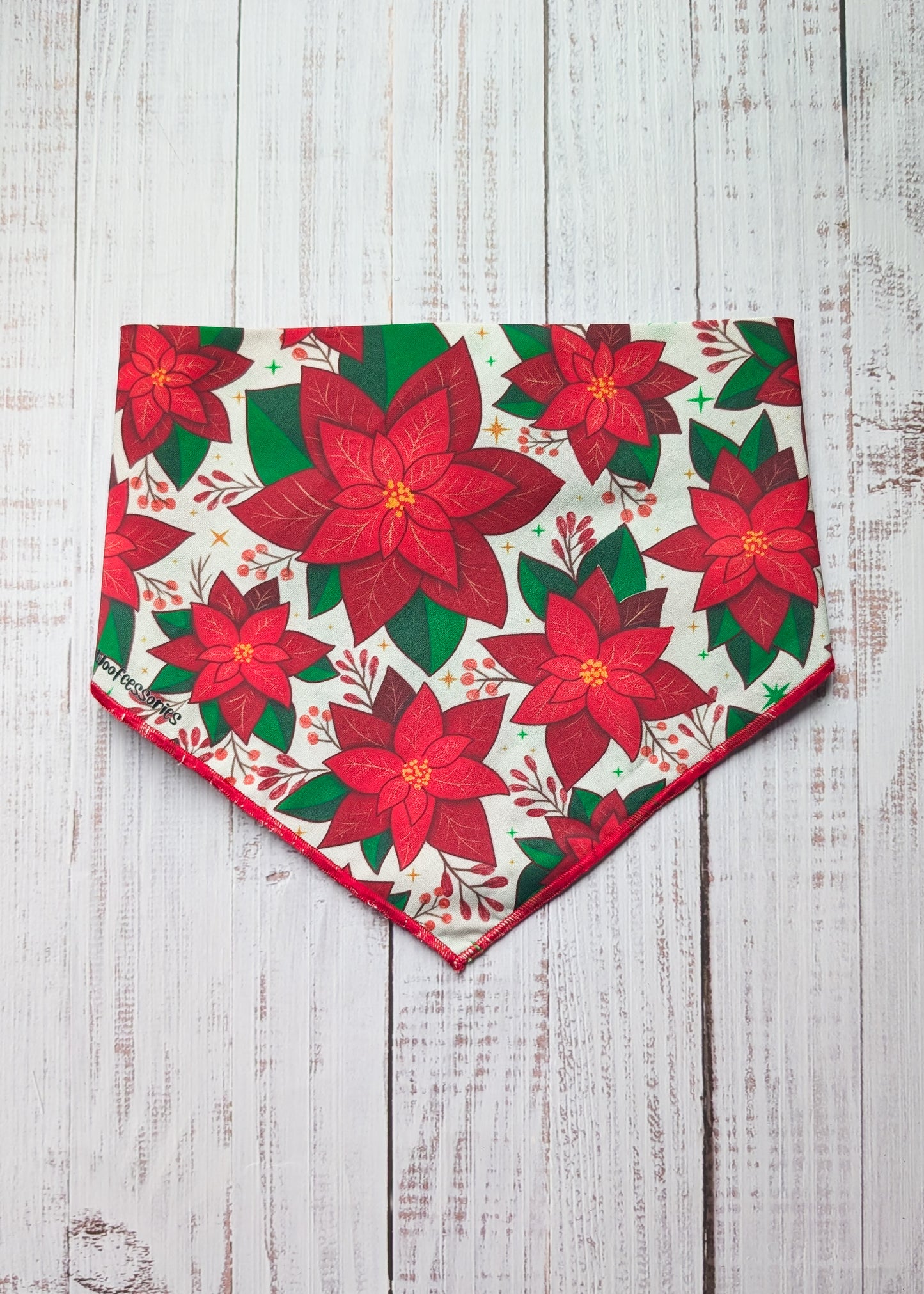 Red poinsettia patterned bandana on a wooden surface